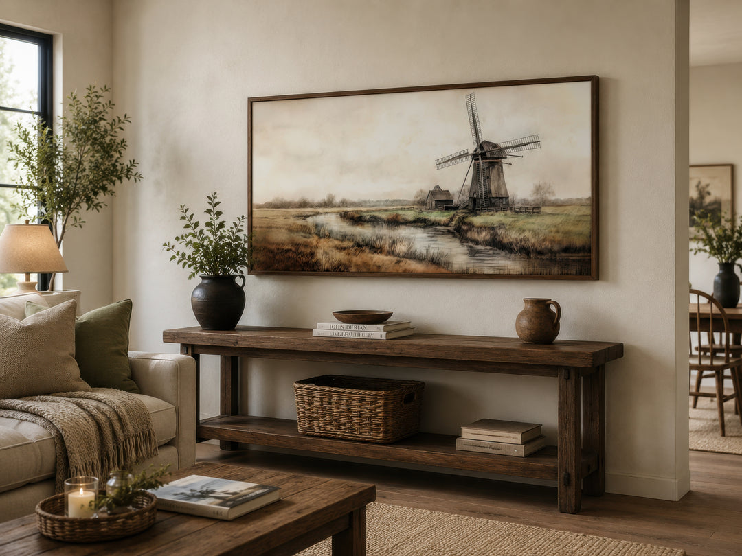 Vintage windmill canvas print in a rustic frame hanging above a wooden console table.