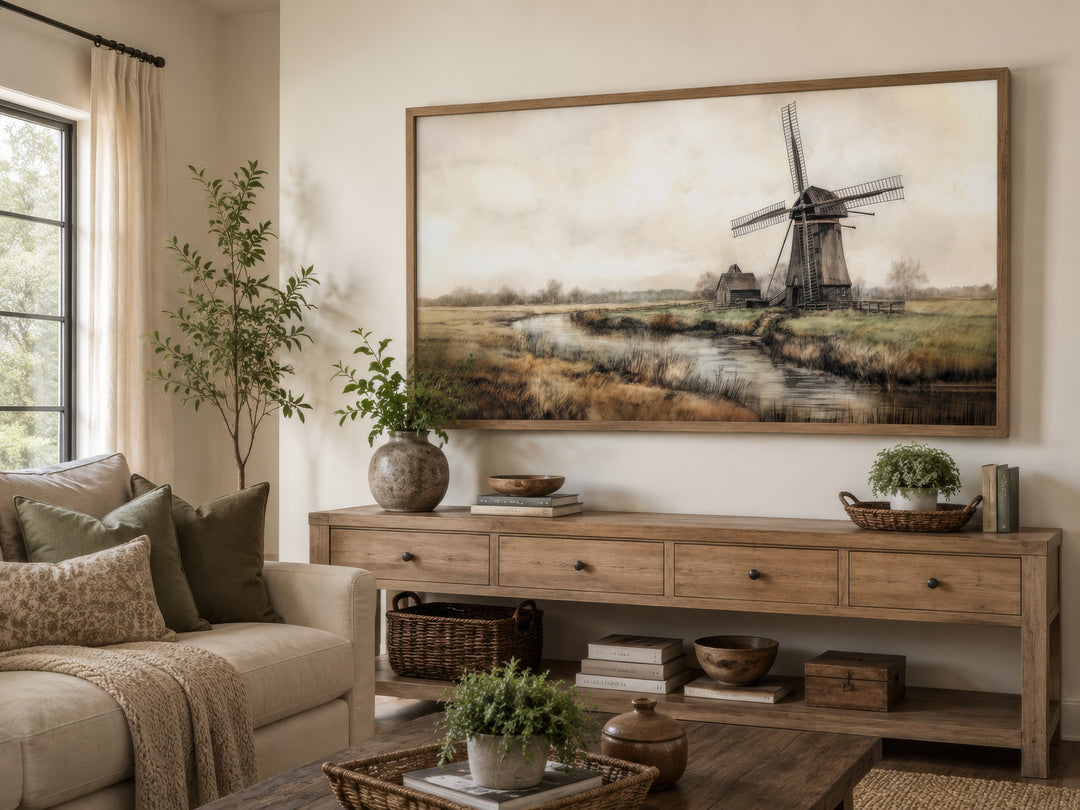 Vintage windmill canvas print in a wooden frame above a rustic console table in a farmhouse room.