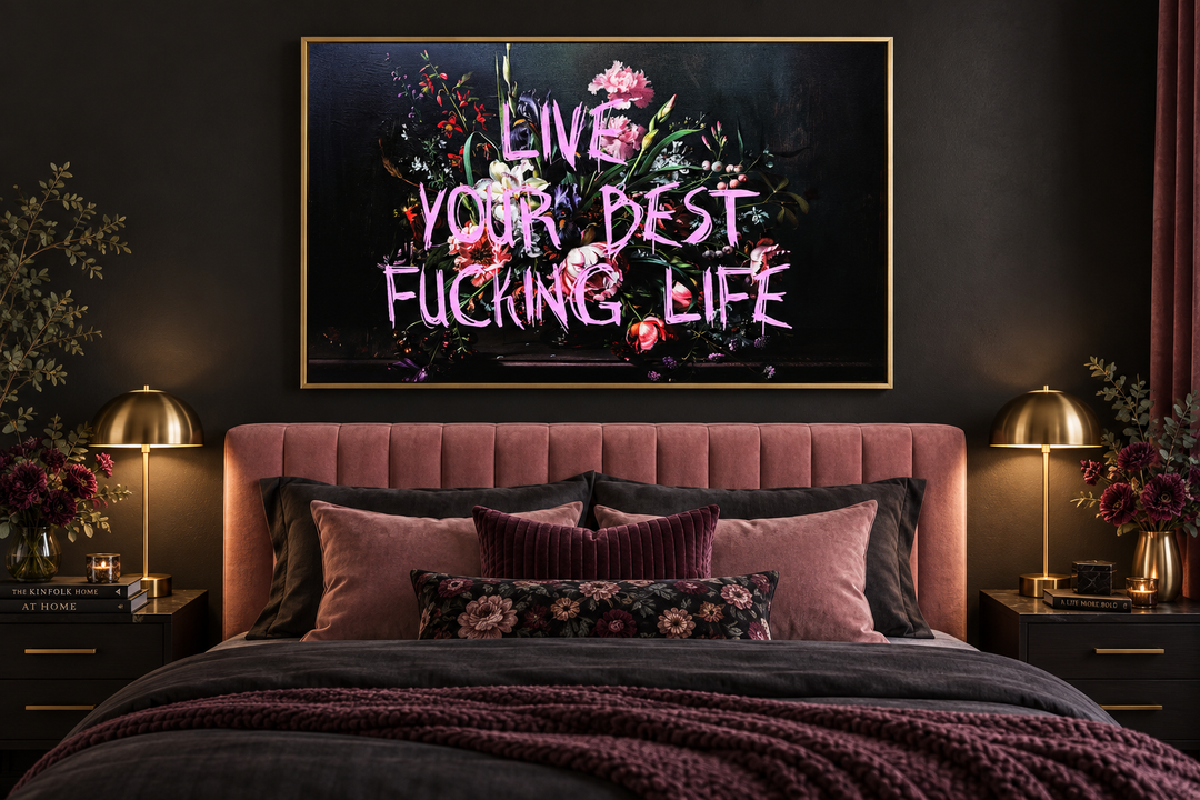 Live Your Best Fucking Life framed wall art with pink graffiti text over dark floral painting.