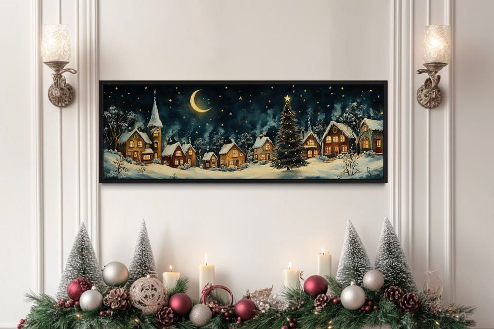Festive Christmas village long narrow framed canvas wall art above a decorated mantel.