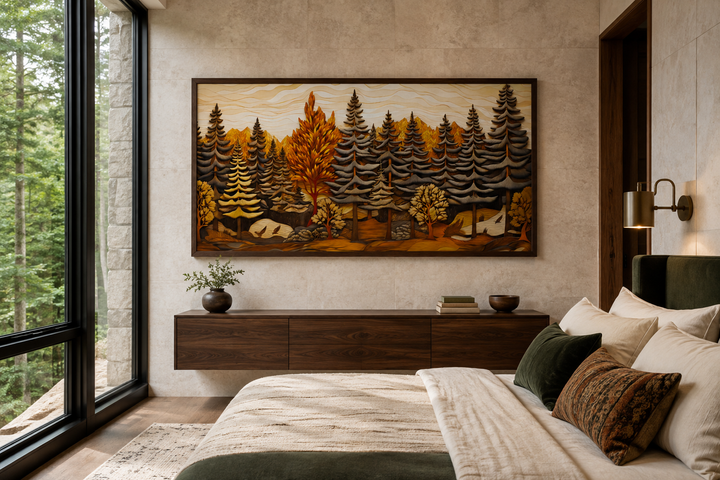 Framed layered wood panel wall art of a fir tree forest in a rustic bedroom setting.