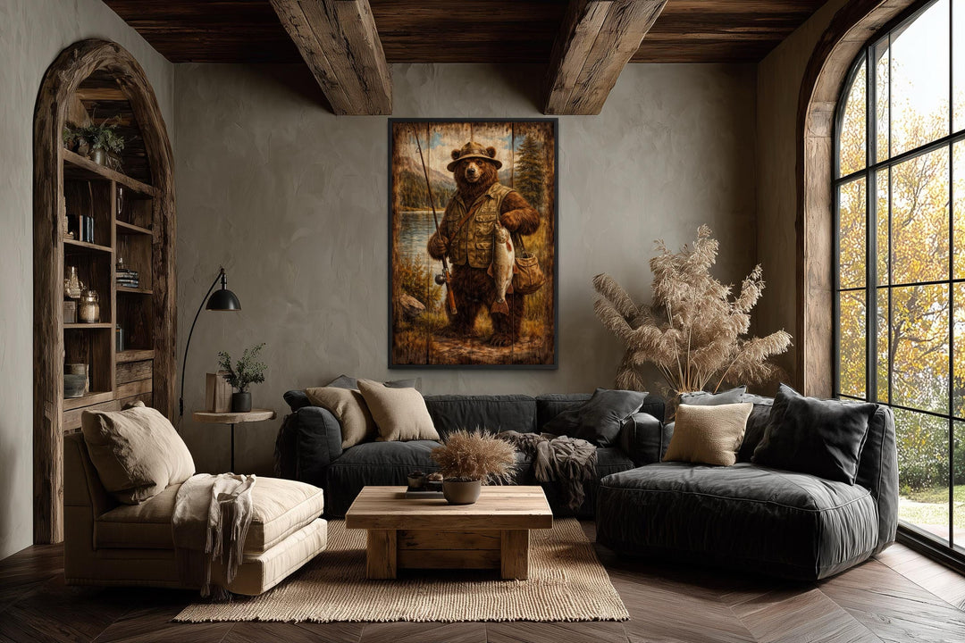 Rustic brown bear fishing artwork in a lodge-style frame centered in a cozy, earthy living room.