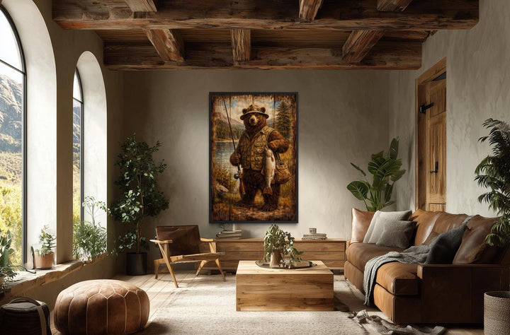 Rustic brown bear fishing wall art in a lodge-style living room with wood beams and leather sofa.