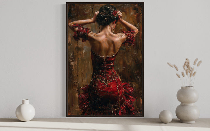 Framed canvas wall art of a flamenco dancer in a red dress, seen from behind with arms raised.