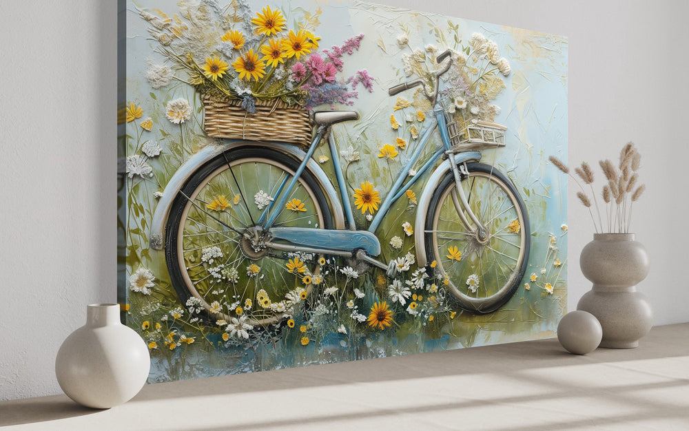 Textured canvas wall art of a blue vintage bicycle with a flower basket in a rustic farmhouse style.