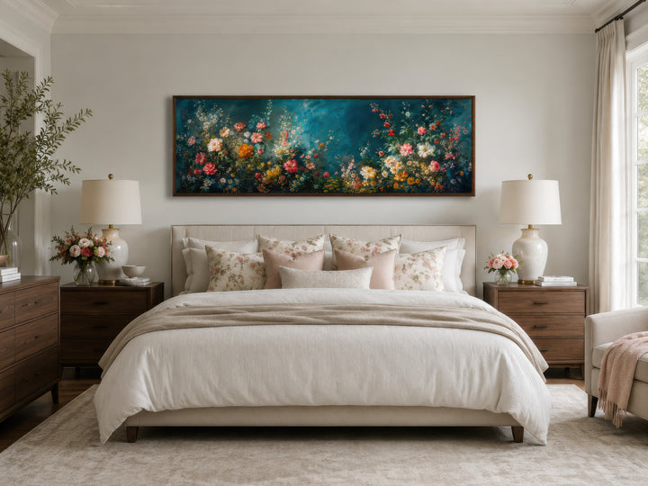 Long narrow canvas wall art featuring a floral garden on a deep teal background above a bed.