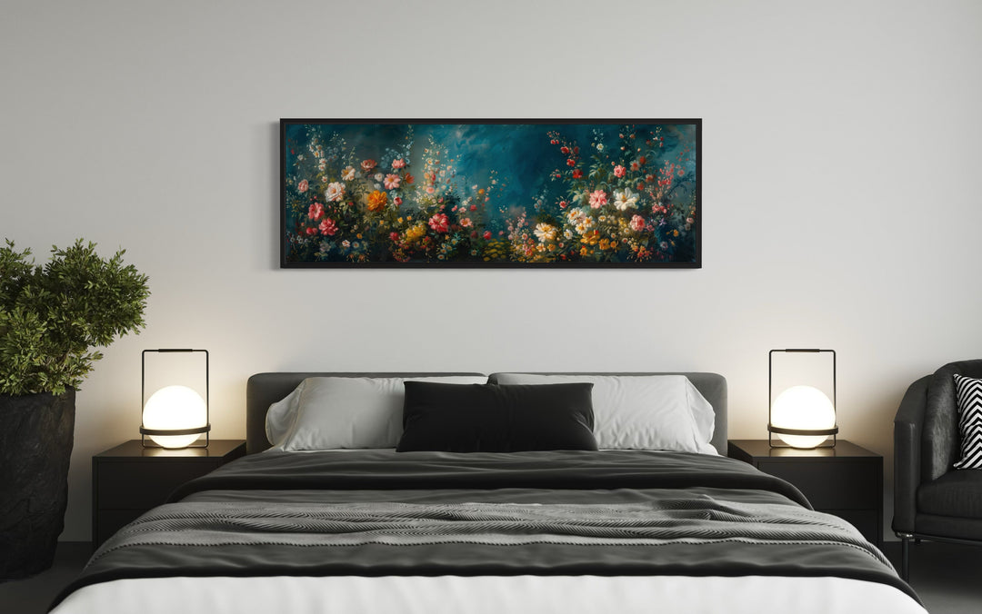Long narrow canvas wall art of a floral garden on a teal background hanging above a modern bed.