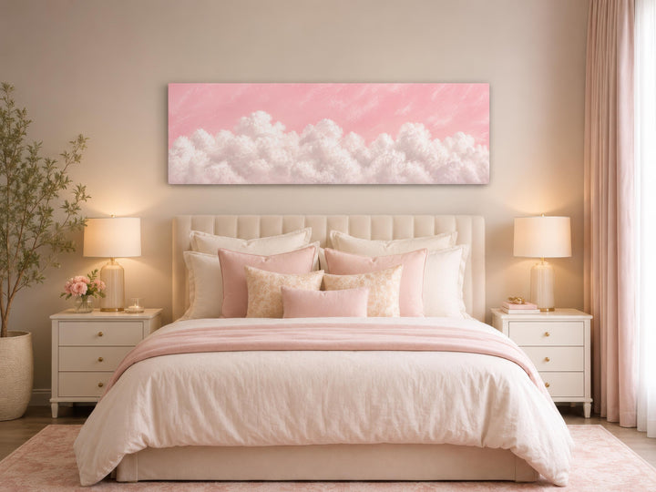 Fluffy White Clouds on a Blush Pink Sky Long Horizontal Canvas Print above a bed in a pink bedroom.