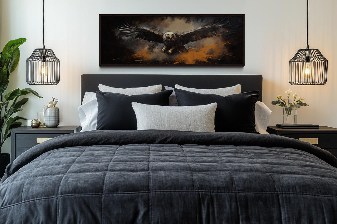 Flying eagle horizontal canvas wall art above a dark bed with black and white pillows.