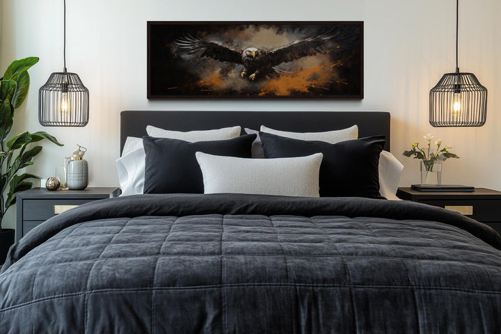 Flying eagle horizontal canvas wall art above a dark bed with black and white pillows.