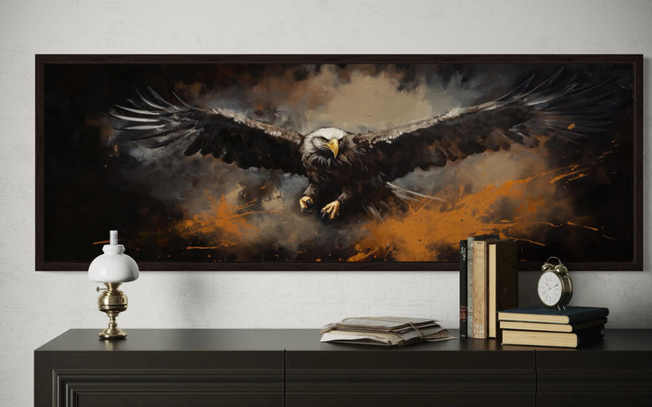 Flying bald eagle horizontal canvas wall art in a dark frame above a black dresser.