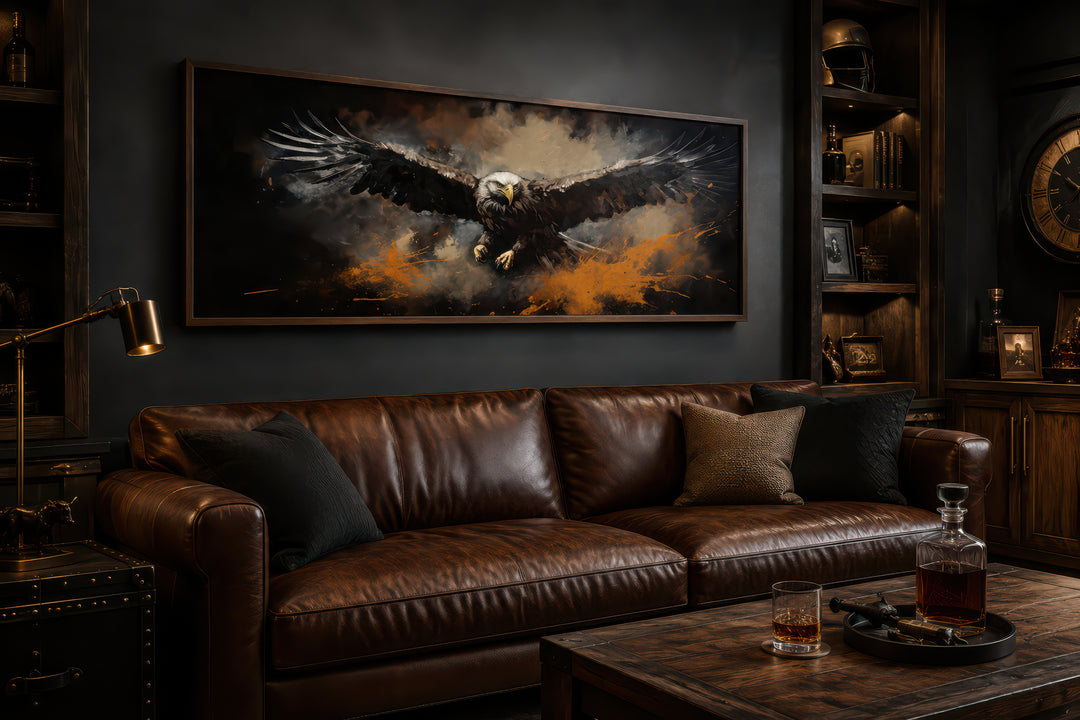 Flying eagle long horizontal canvas wall art in a dark, masculine living room above a leather sofa.