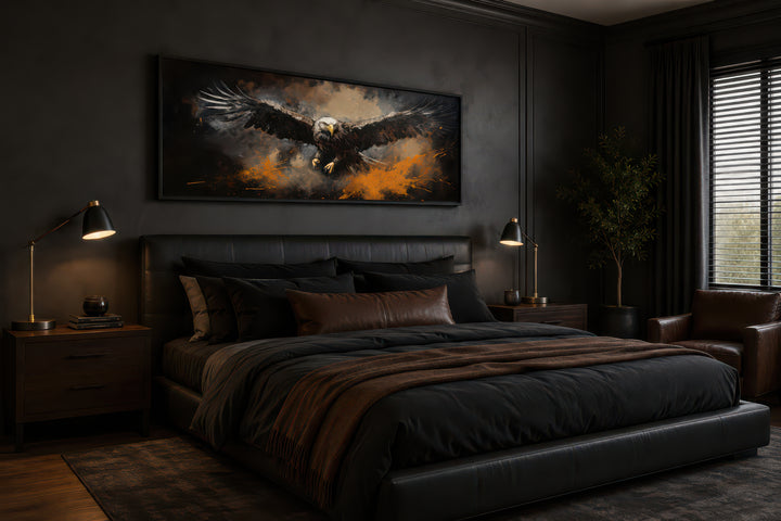 Flying eagle long horizontal canvas wall art above a black leather bed in a dark, modern bedroom.