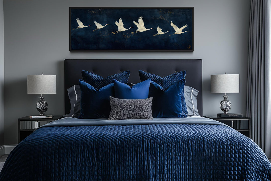 Panoramic navy blue canvas print featuring a horizontal flight of elegant white cranes.