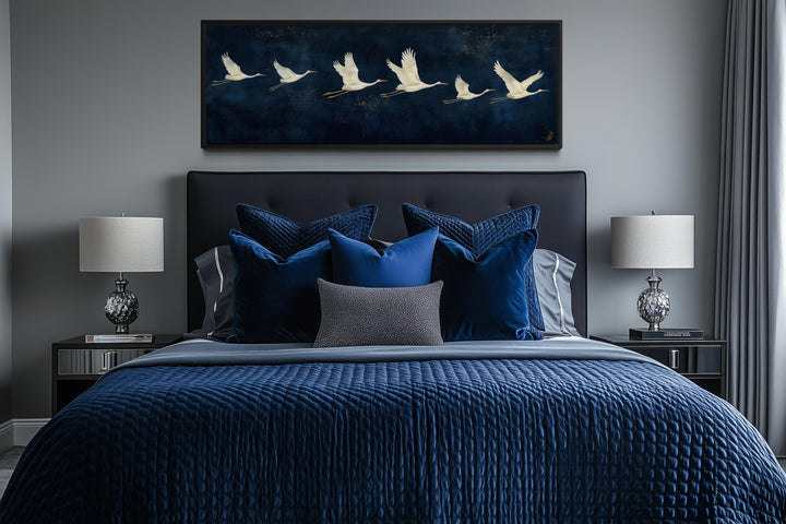 Panoramic navy blue canvas print featuring a horizontal flight of elegant white cranes.