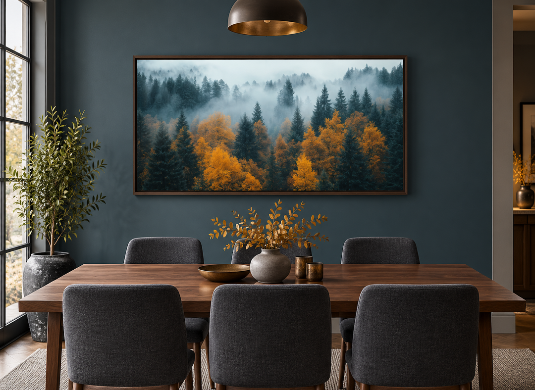 Moody Foggy Forest Framed Canvas Wall Art in a walnut frame above a modern dining table.