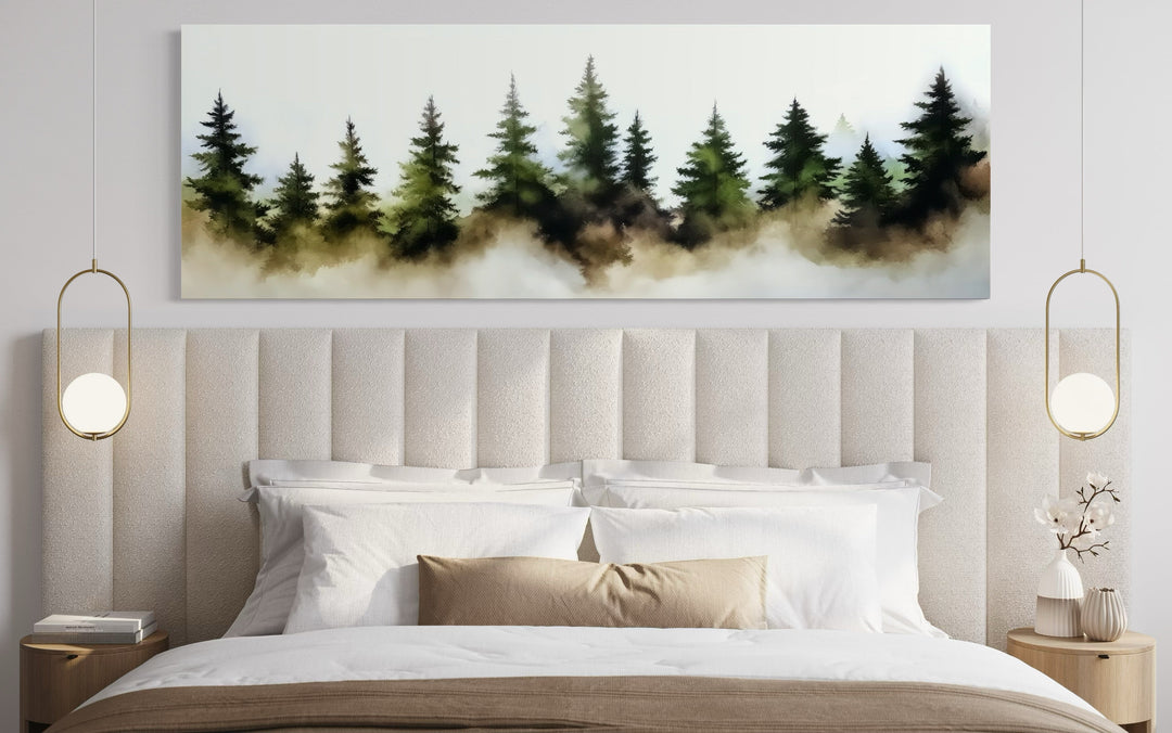 Foggy green pine trees forest horizontal wall art hanging above a bed in a modern bedroom.