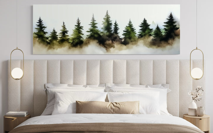 Foggy green pine trees forest horizontal wall art hanging above a bed in a modern bedroom.