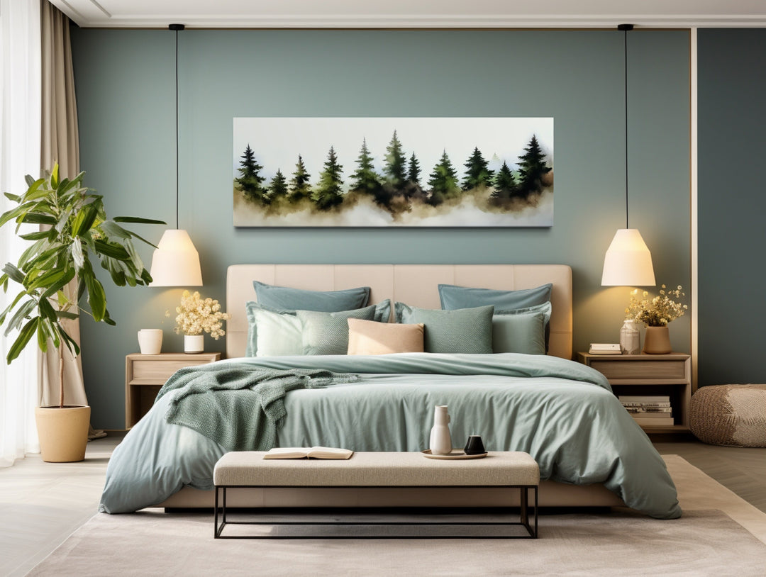Foggy green pine tree forest watercolor horizontal wall art hanging above a bed in a bedroom.