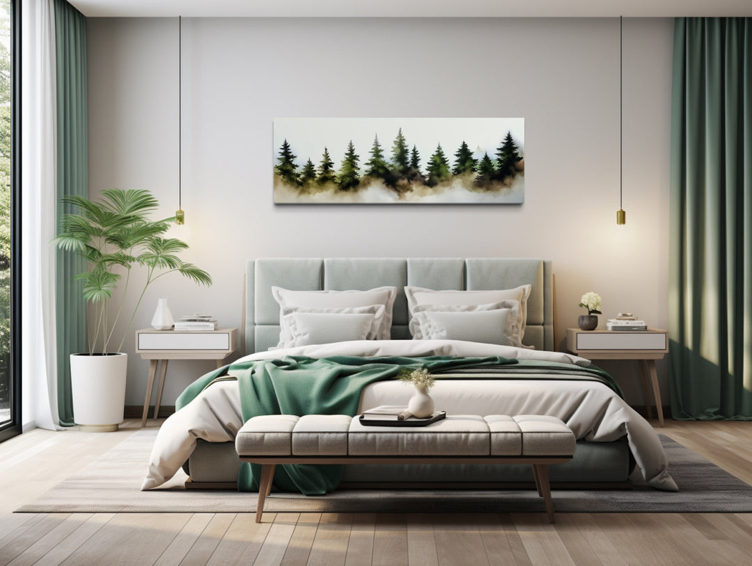Foggy green pine trees forest horizontal watercolor wall art hanging above a bed in a bedroom.
