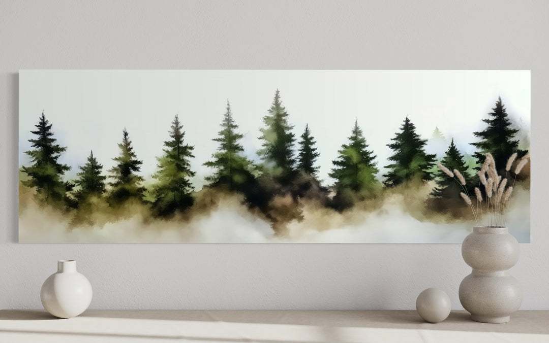 Panoramic watercolor wall art of a foggy green pine tree forest above a minimalist shelf.