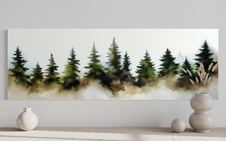 Panoramic watercolor wall art of a foggy green pine tree forest above a minimalist shelf.