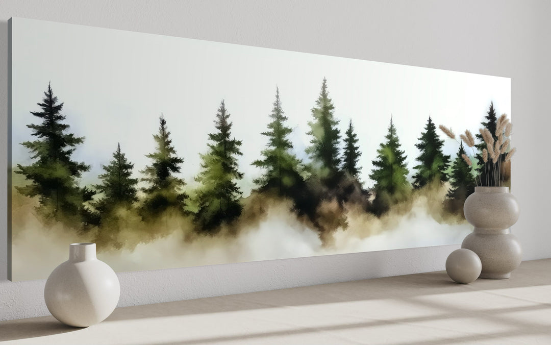 Panoramic watercolor wall art of foggy green pine trees in a misty forest above a bed.