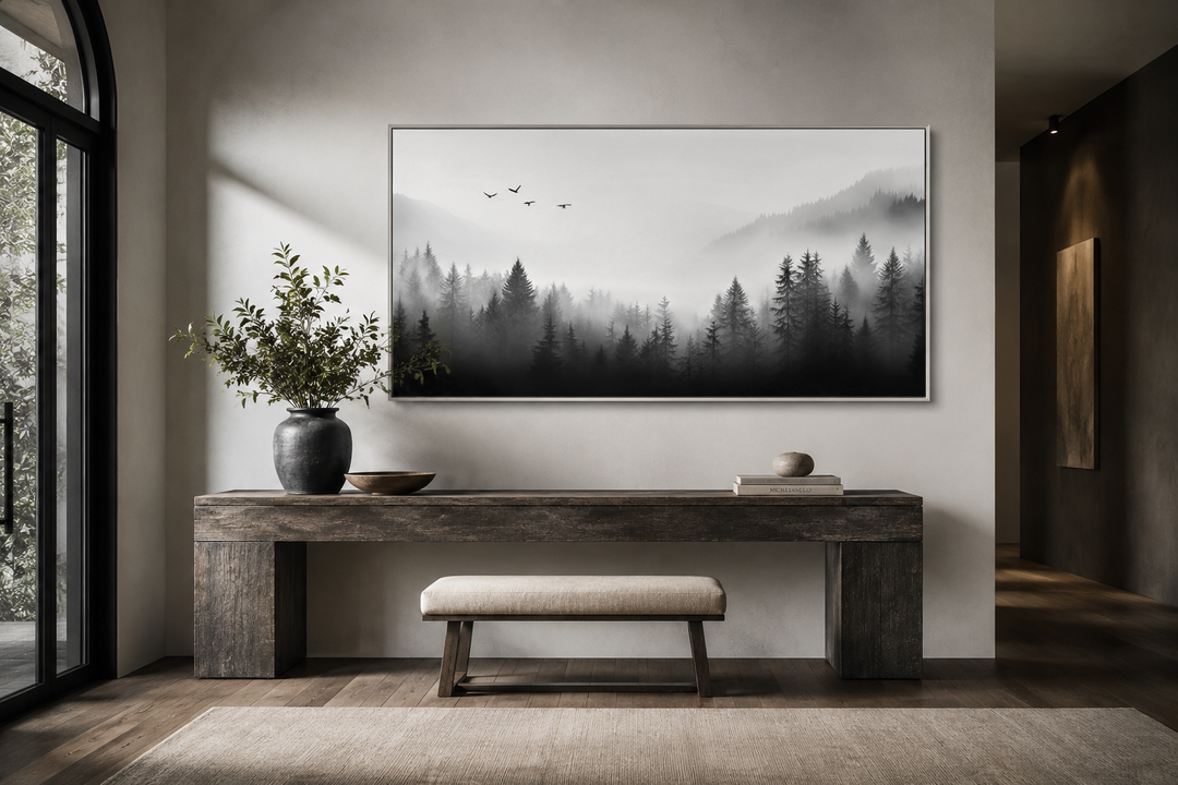 Foggy forest black and white minimalist framed canvas wall art above a wooden console table.