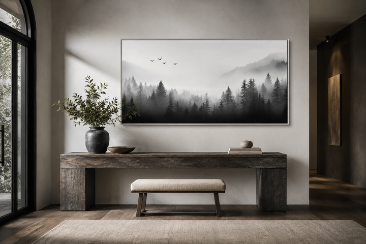 Foggy forest black and white minimalist framed canvas wall art above a wooden console table.