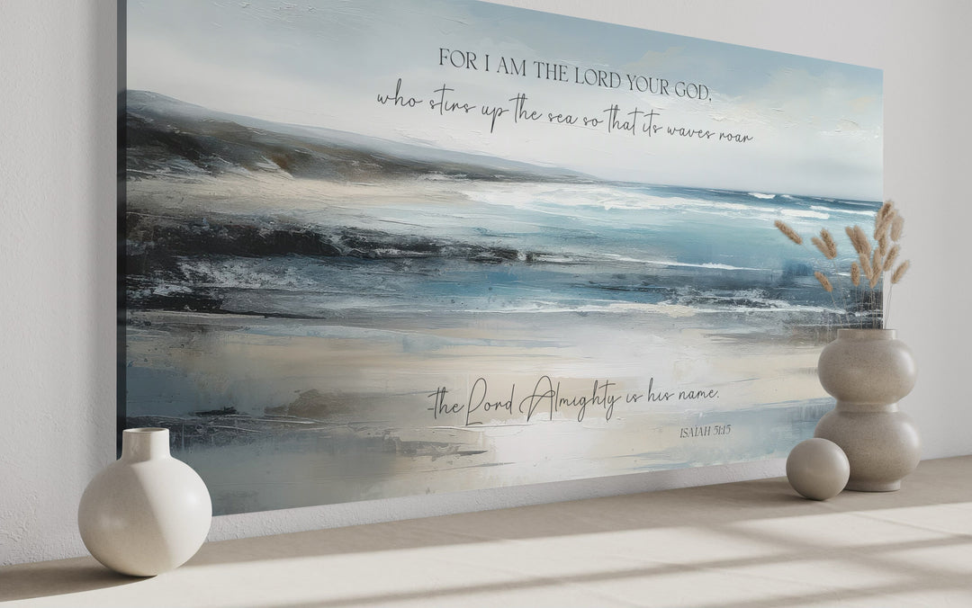 Coastal canvas wall art with Isaiah 51:15 scripture over an abstract blue and gray ocean painting.