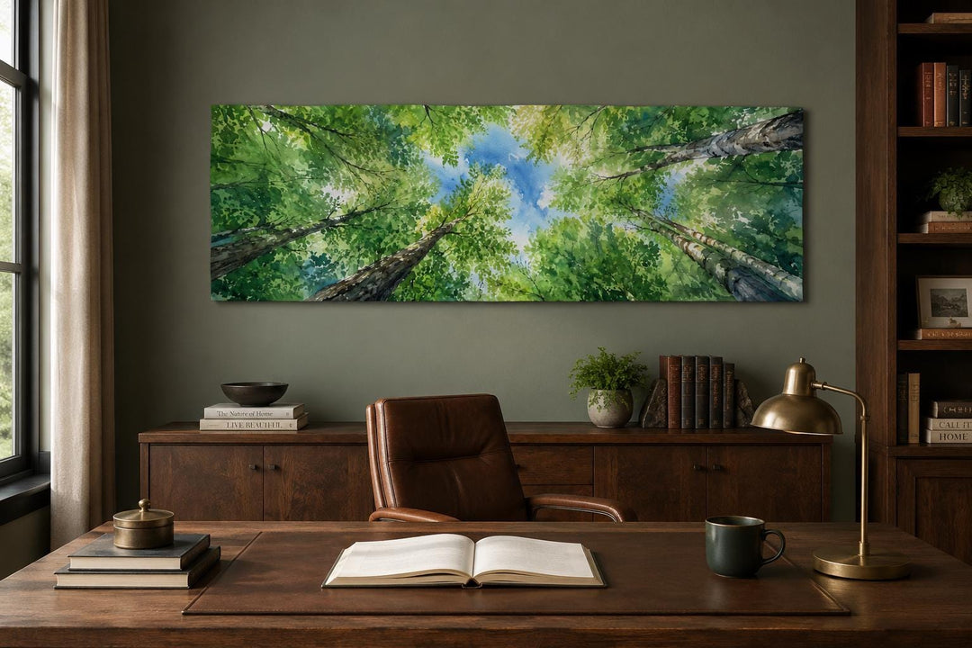 Wide forest canopy wall art showing an upward view of green trees and blue sky in a home office.