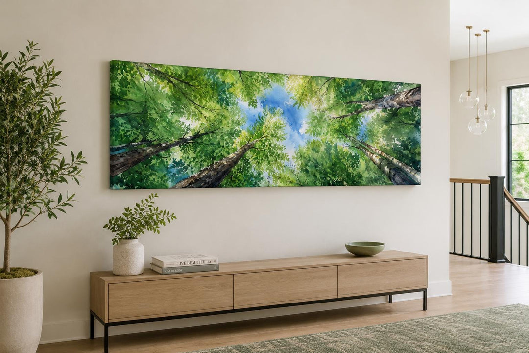 Wide canvas art of a forest canopy looking up through green leaves and tree trunks to a blue sky.