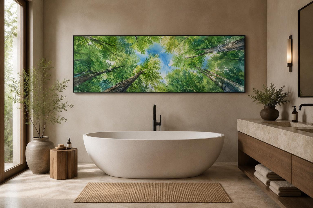 Panoramic forest canopy wall art showing an upward view of green trees and blue sky over a bathtub.