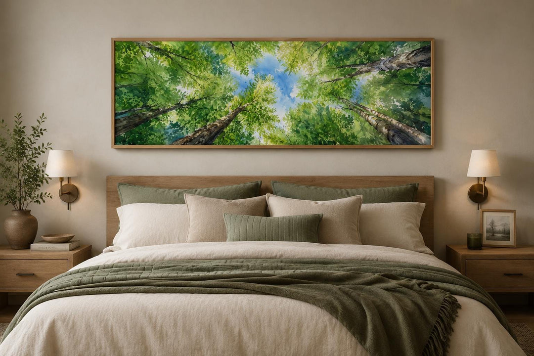 Wide forest canopy wall art with green trees and blue sky above a bed in a modern farmhouse room.