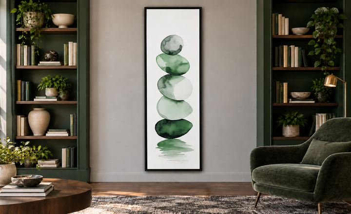 Tall narrow framed canvas wall art featuring forest green watercolor stacked rocks on white.