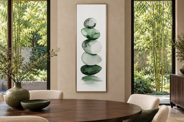 Vertical framed canvas wall art featuring forest green and white watercolor stacked rocks.