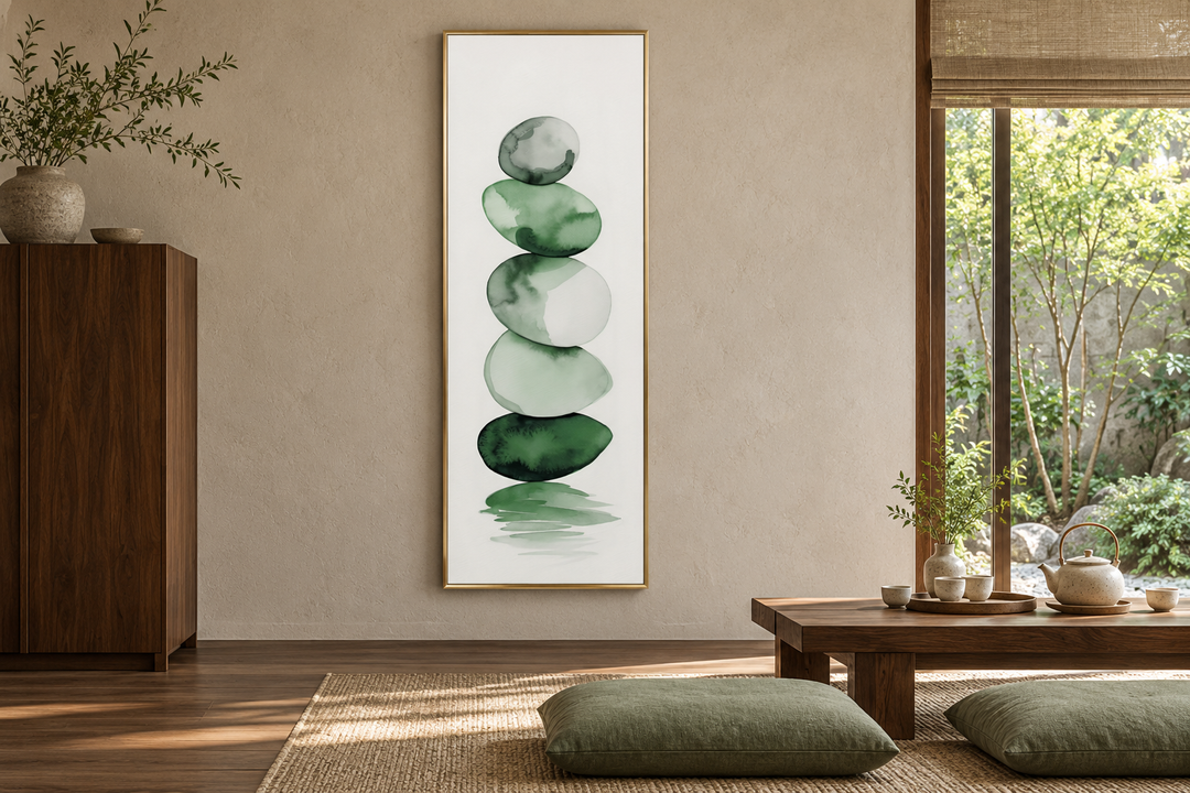 Tall narrow framed canvas art of stacked forest green and white watercolor rocks in a zen tea room.
