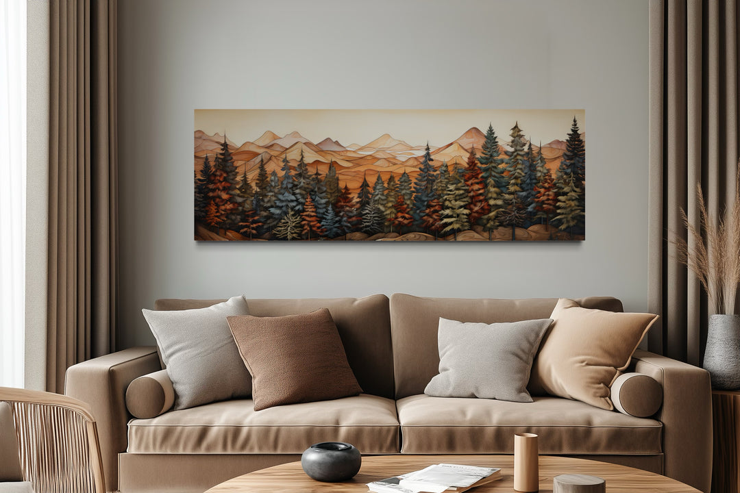 Panoramic forest and mountain landscape canvas art hanging above a tan sofa in a modern room.