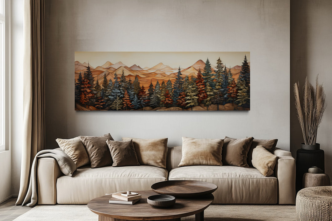 Long horizontal canvas art of a forest and mountains above a beige sofa in a rustic living room.