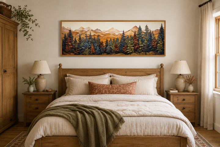 Long horizontal canvas wall art of a painted forest and mountains above a rustic wooden bed.