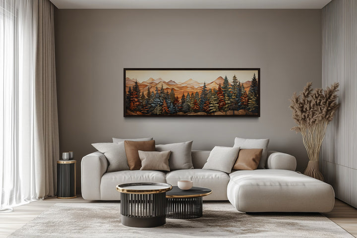 Panoramic forest and mountain landscape painting on wood-textured canvas above a modern sofa.