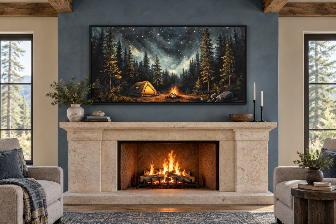 Framed canvas art of a campfire and tent under a starry night sky above a stone fireplace mantel.