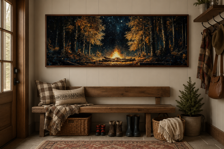 Panoramic wall art of a glowing campfire in a dark forest, hung above a rustic wooden bench.