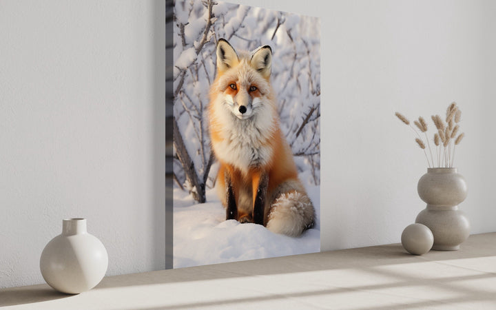 Fox in Snow Photography Style Framed Canvas Wall Art leaning against a white wall.