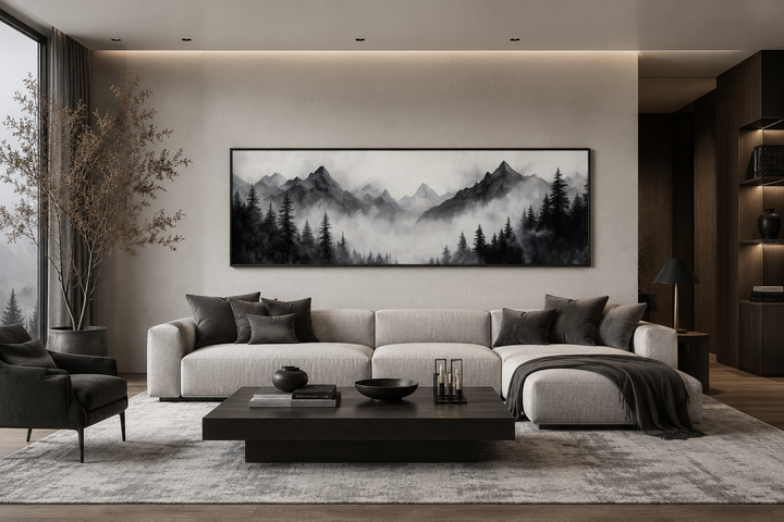 Black and white watercolor foggy mountain forest long horizontal wall art above a modern sofa.