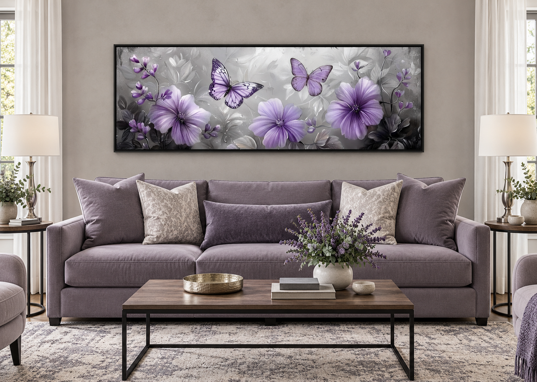 Horizontal wall art of purple flowers and butterflies above a lavender sofa in a living room.