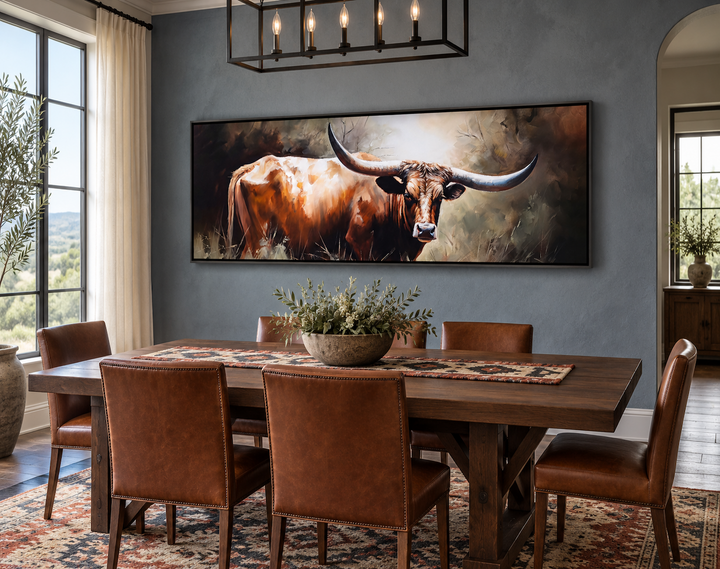 Texas Longhorn Steer panoramic framed canvas wall art above a dining table in a rustic room.