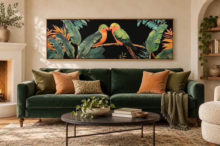Lovebirds in tropical rainforest long horizontal framed canvas wall art above a green velvet sofa.