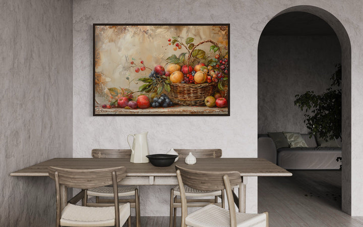 Framed canvas wall art of a rustic fruit basket hanging in a neutral-toned dining room.