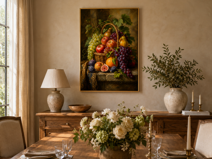 Framed fruit basket still life painting hanging above a wooden sideboard in a dining room.